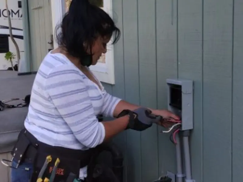 Licensed electrician wiring an exterior subpanel in Krum